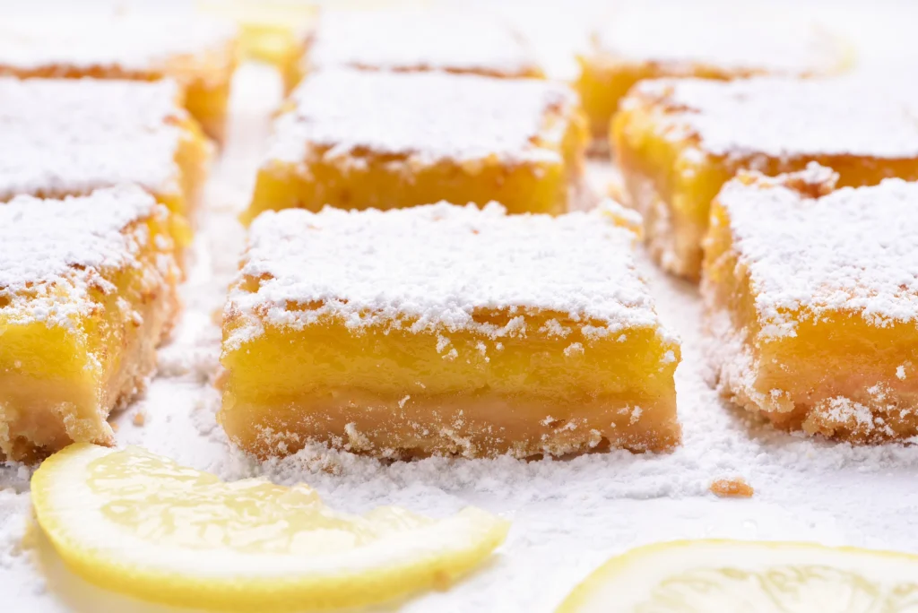 Close-up of lemon cream cheese bars dusted with powdered sugar